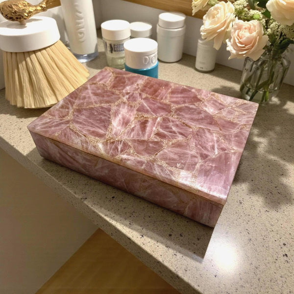 Crystal gift boxes with rose quartz and amethyst jewelry on velvet