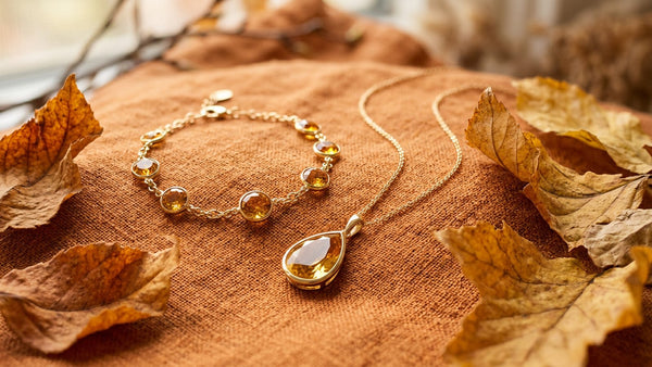Citrine bracelet and topaz pendant styled with autumn leaves