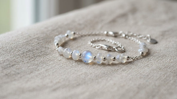 Moonstone and rainbow moonstone bracelet on neutral linen background